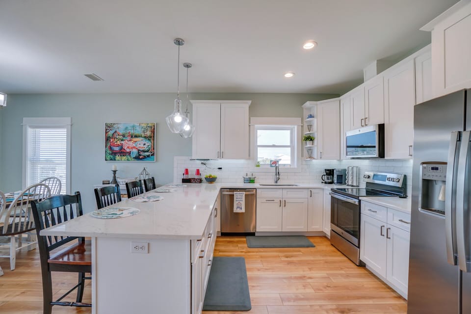 Your spacious kitchen features modern appliances, a large island perfect for cooking together, and bright natural light streaming in.