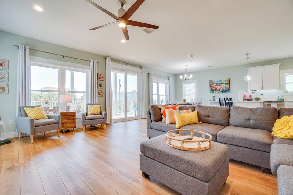Relax in your spacious living room with cozy sectional seating, natural light streaming through sliding doors, and modern touches throughout.