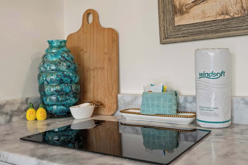 A cute kitchenette and cooktop for your cooking needs.
