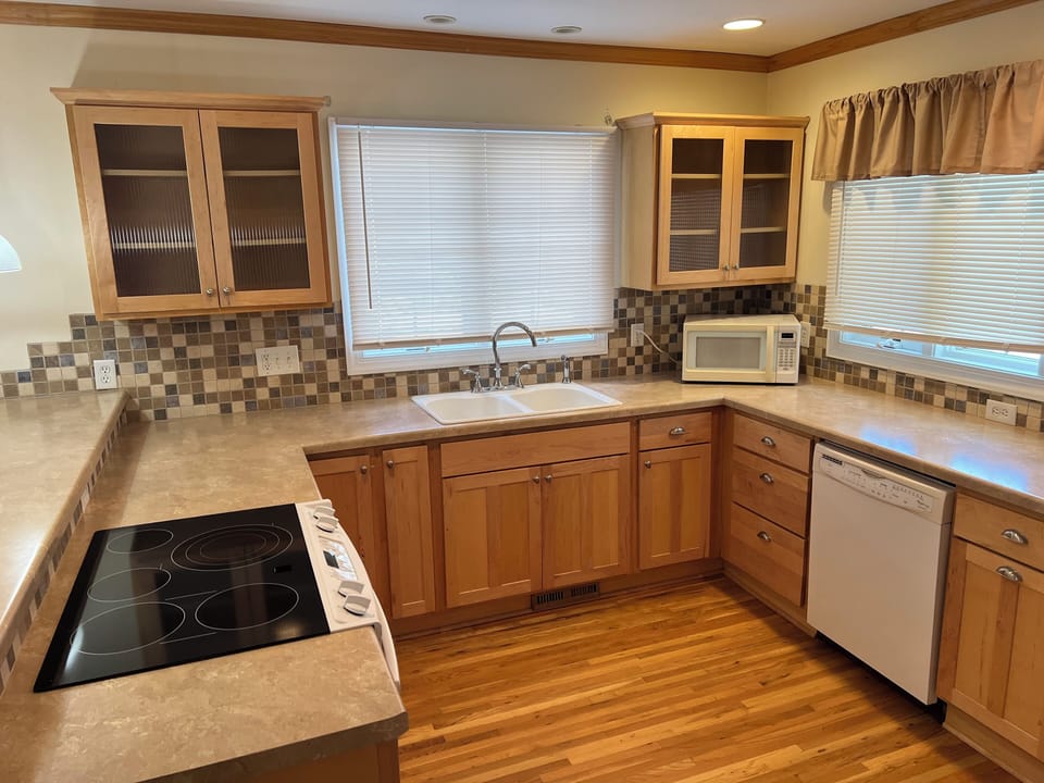Full kitchen with basic cooking and dining essentials. 