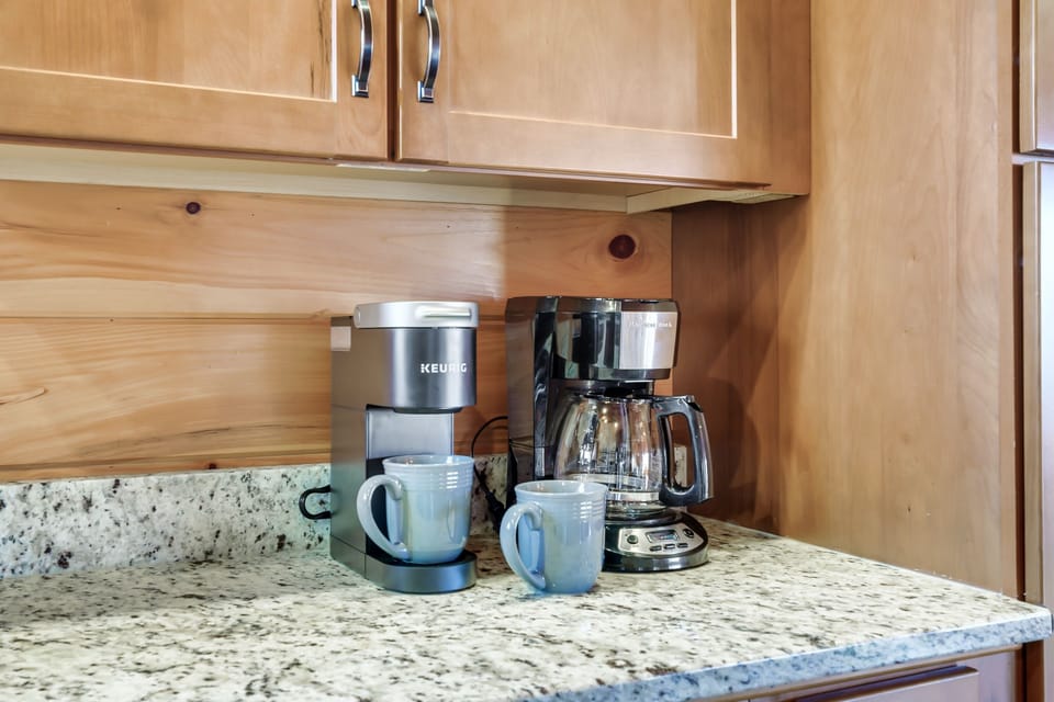 Coffee bar area stocked with pods, sweeteners, creamers & teas