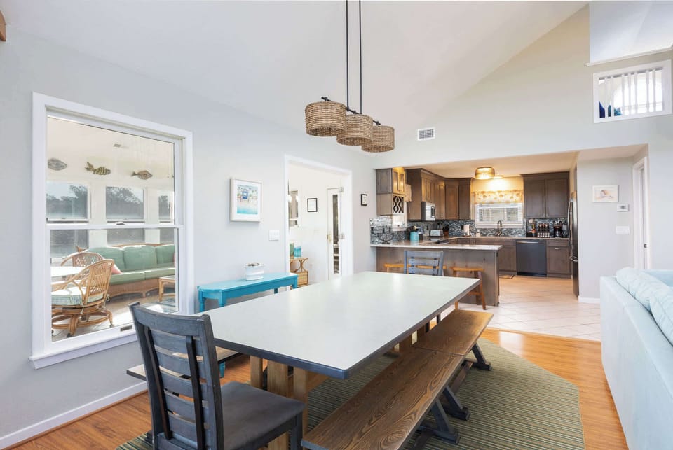 Top Level: Airy Dining Room w/ Farmhouse Table, Bench & Chair Seating, Woven Pendant Light, and Warm Hardwood Floors