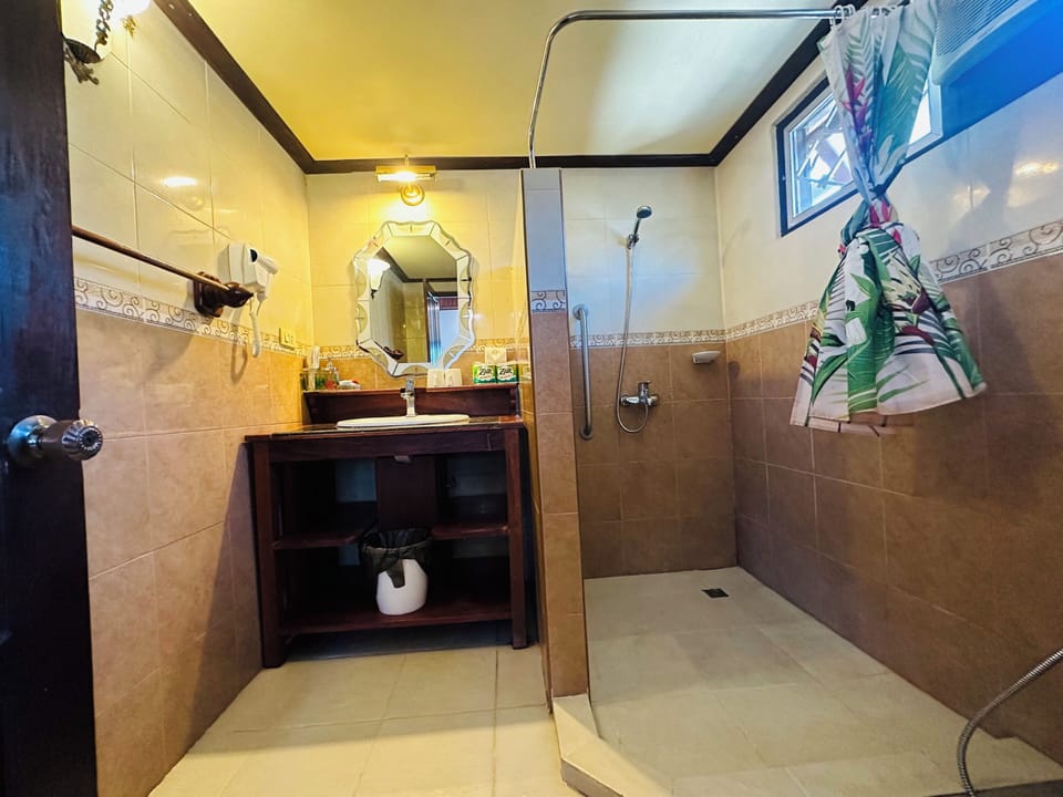 Deluxe Quadruple Room, Courtyard View | Bathroom | Shower, hair dryer, slippers, towels
