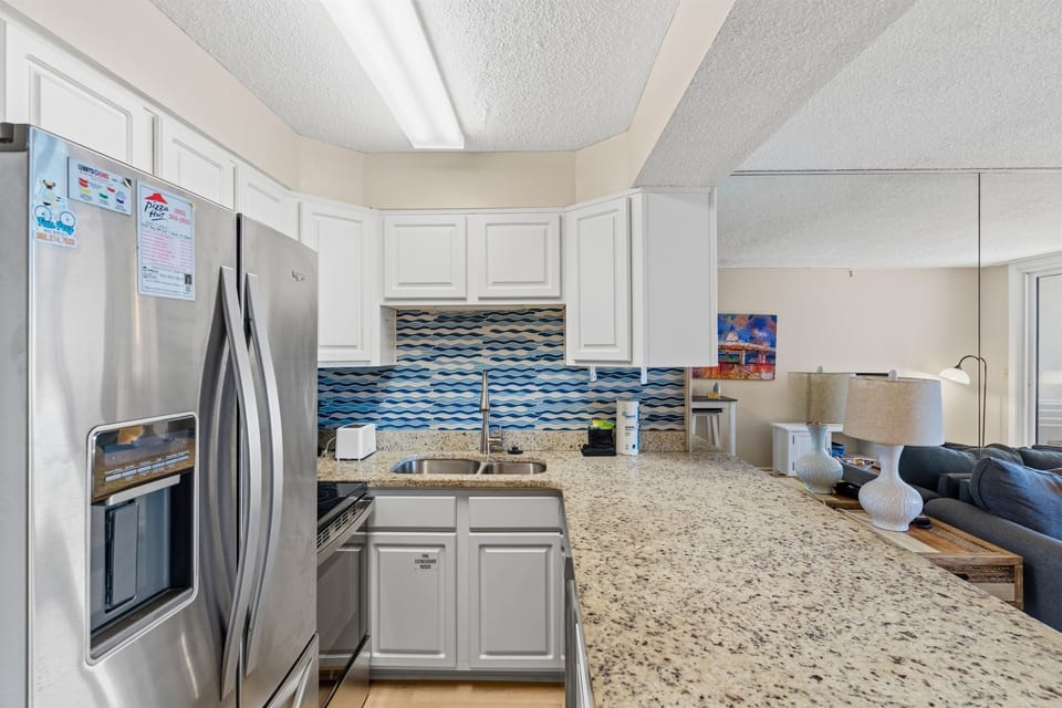 This beautifully updated kitchen offers coastal charm with modern convenience and style. 