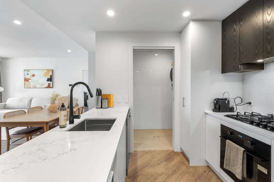 Open kitchen layout flowing into the dining and living area, creating a welcoming space to cook, eat and relax.