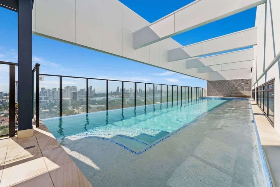 Poolside view – Sparkling blue water with shaded seating areas nearby.