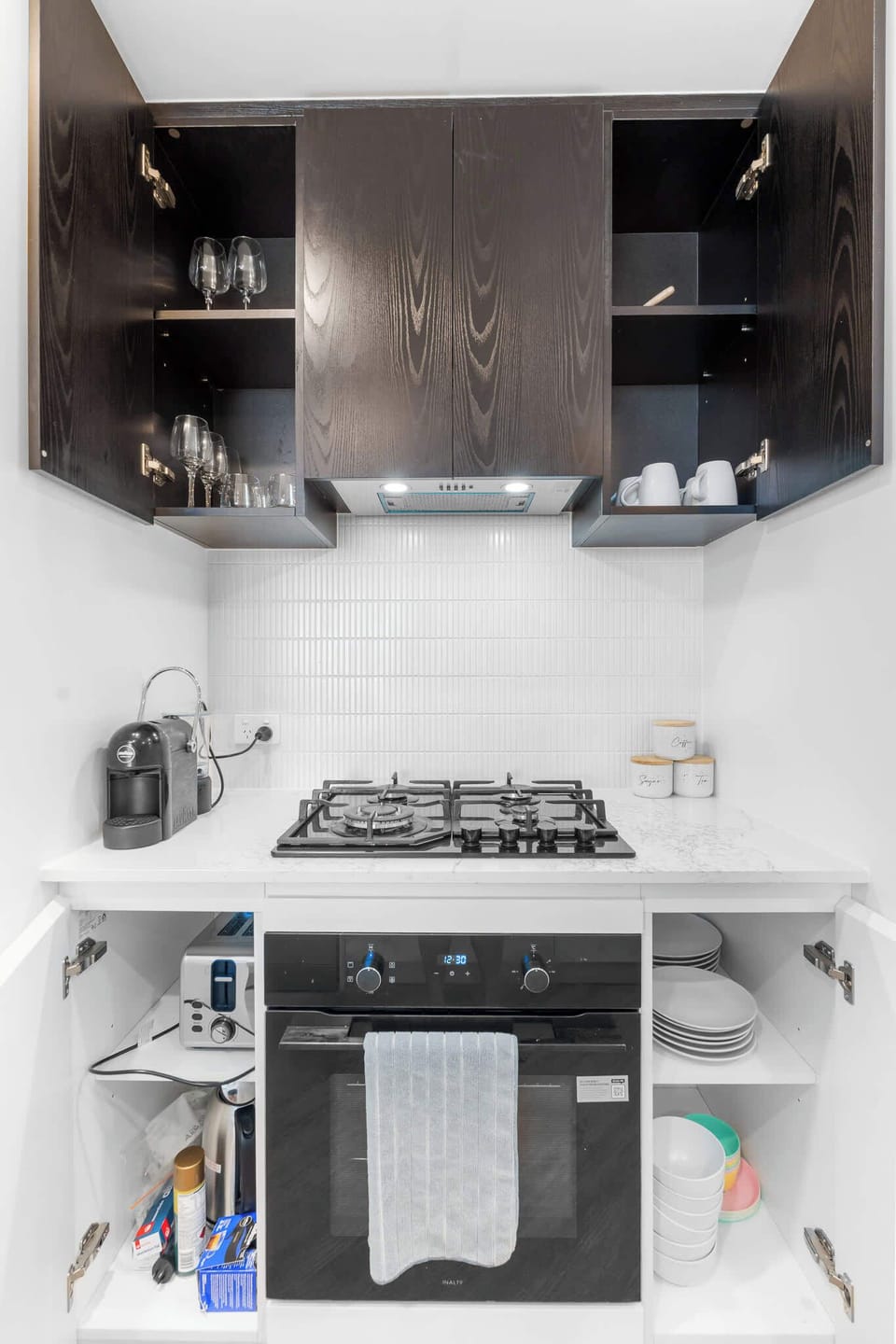 Cupboards are fully stocked with plates, bowls, glasses and basic cookware, making the space perfect for longer stays or home cooked meals.