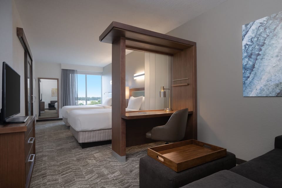 Premium bedding, desk, laptop workspace, iron/ironing board
