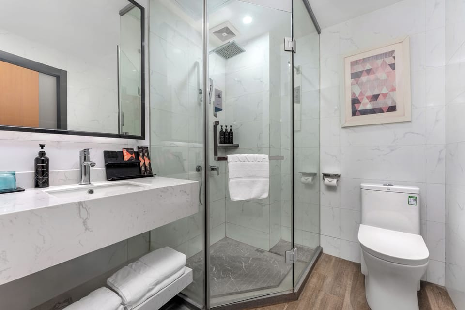 Shower, hair dryer, slippers, towels
