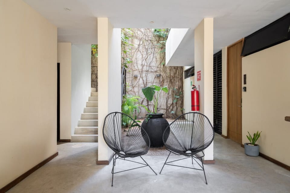 Inviting lobby with modern chairs and a calming garden view. Perfect welcome spot.
