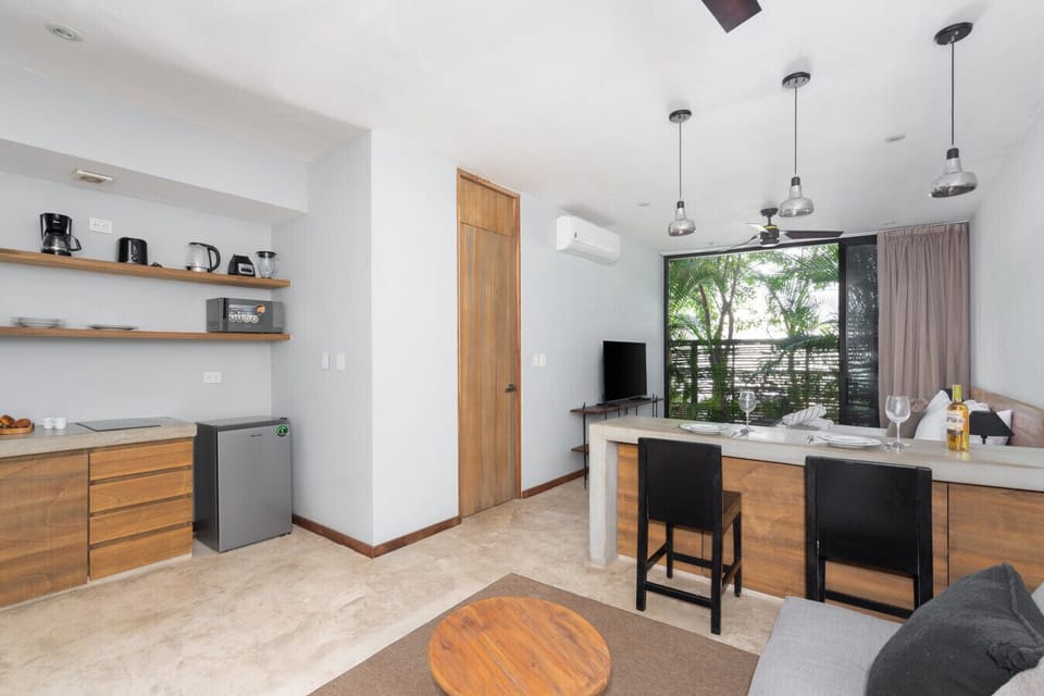 Bright, airy studio with comfy sofa, dining area, large windows, and Wi-Fi.