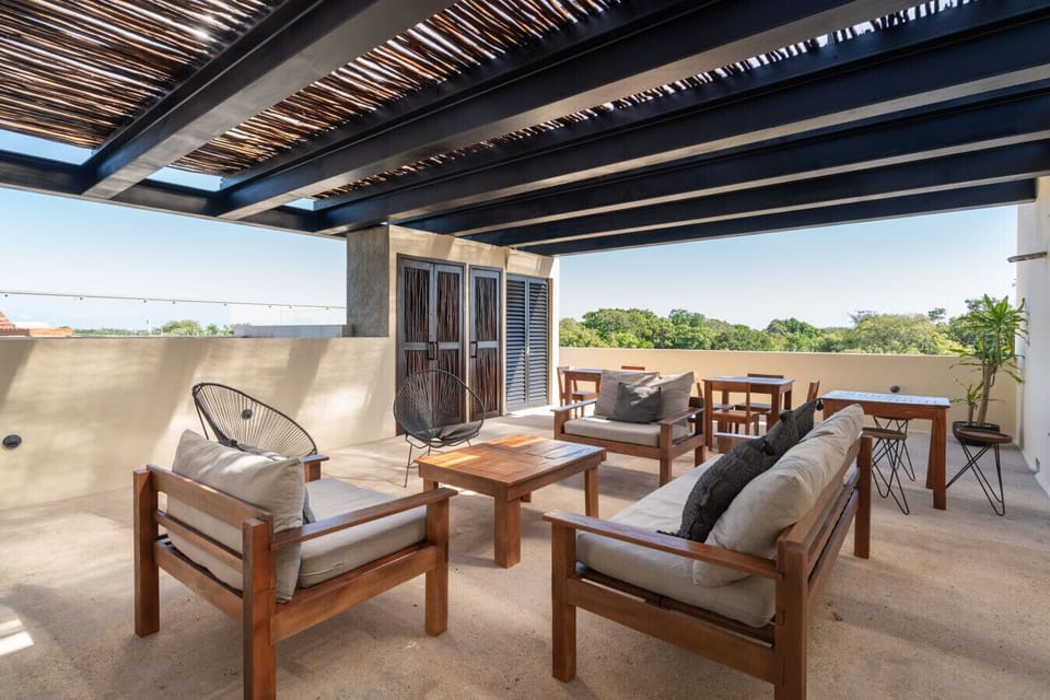 Rooftop area with comfy chairs, beautiful views, and a pleasant atmosphere.