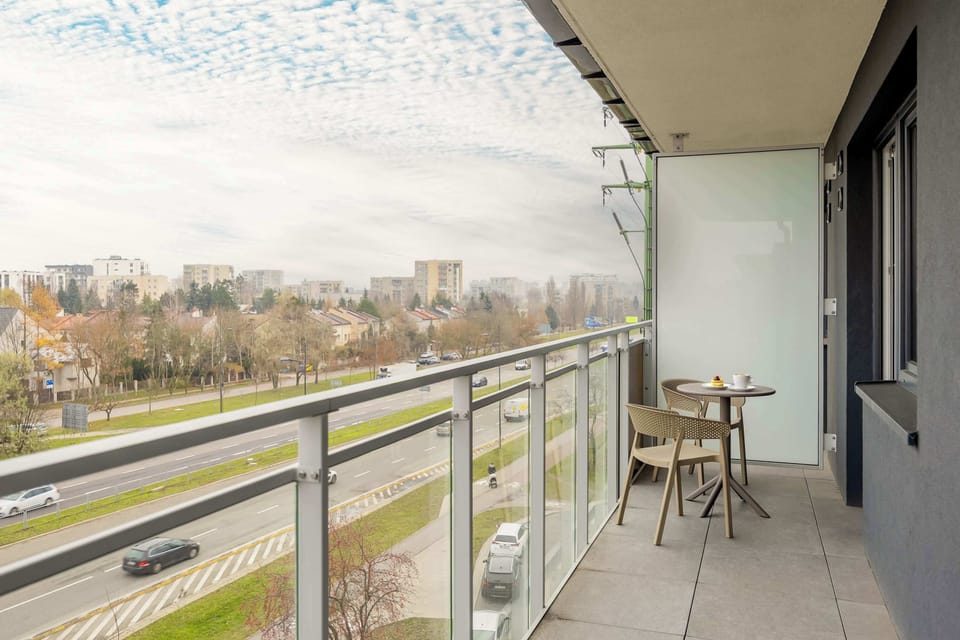 The balcony with its set of outdoor furniture invites guests to enjoy the fresh air and views, becoming a favorite spot for morning coffee.