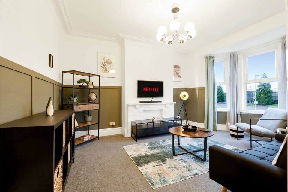 Bright, spacious living area with comfortable seating, smart TV, and plenty of room for everyone to unwind after a long day. Ideal for relaxing, socialising, or movie nights with your group.