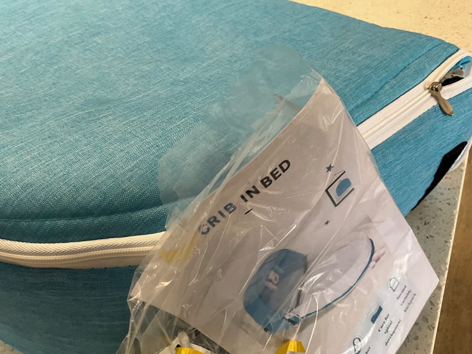 Folding Baby snug bed provided for guest use waterproof sheets & blanket