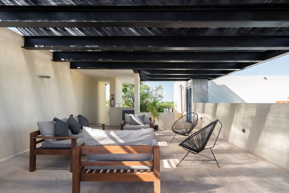Poolside lounge with cozy chairs, calm setting, and a relaxing vibe.