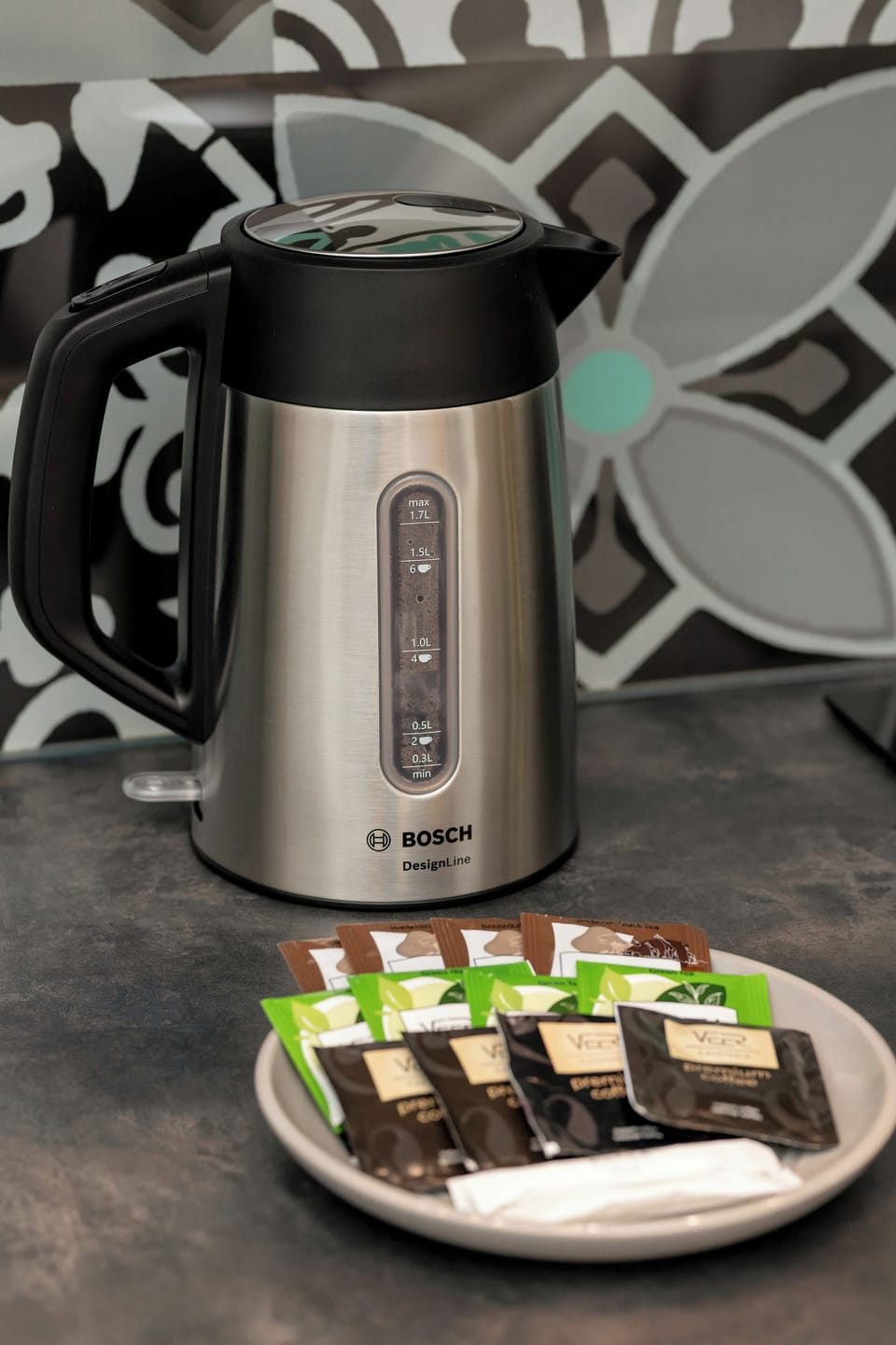An electric kettle placed on the counter makes it easy to prepare your favourite tea or morning coffee, offering convenience at any time of day.