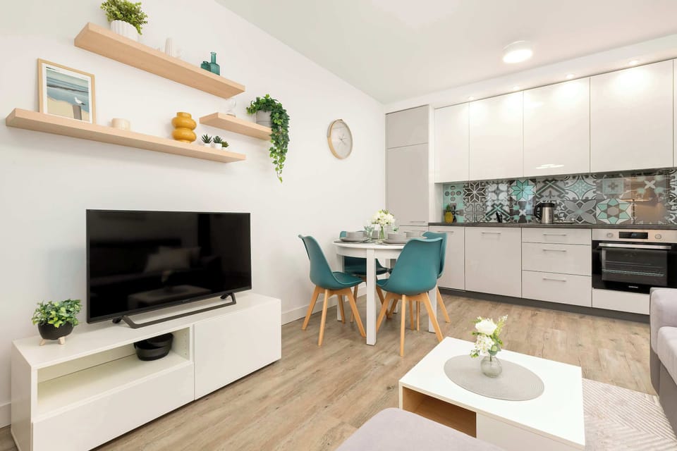 A bright interior with pastel details and a dining spot provides a cosy atmosphere ideal for spending quality time together.
