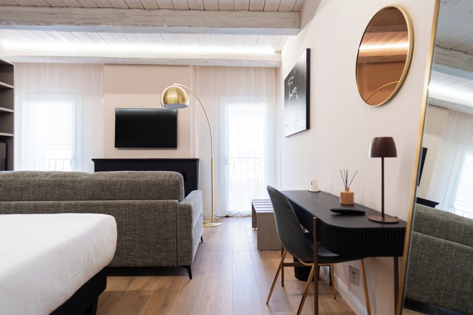 Deluxe Quadruple Room | In-room safe, desk, laptop workspace, blackout drapes