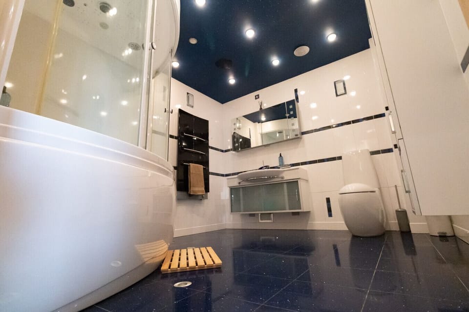 Spacious tiled bathroom with modern fittings