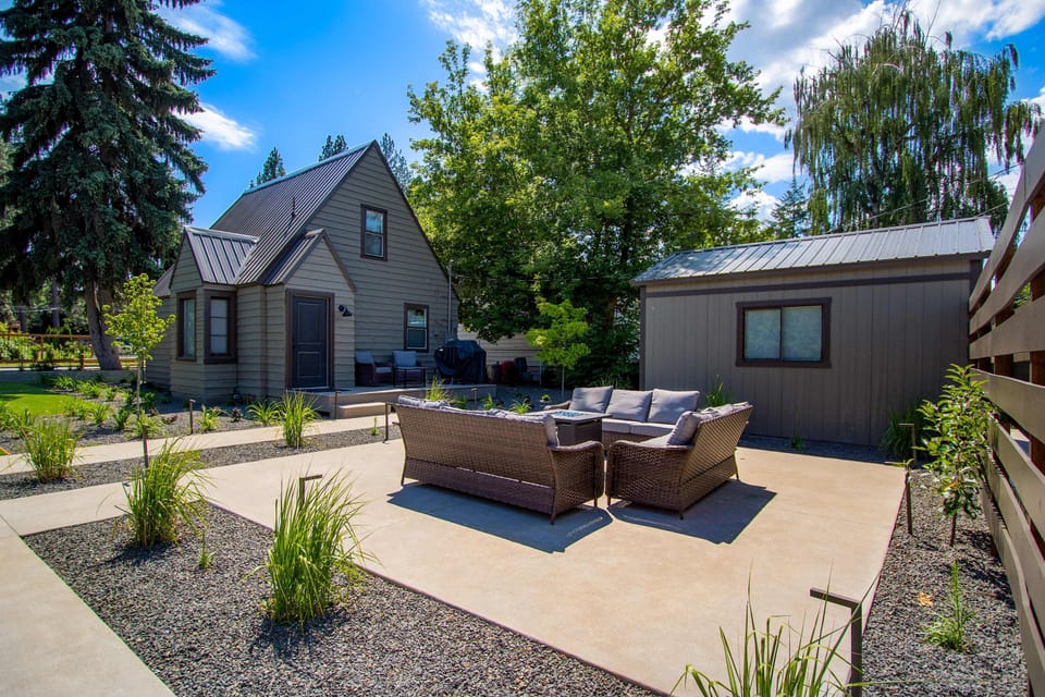Sunlit backyard patio with wicker sectional seating - your quiet decompression zone after a day on the lake