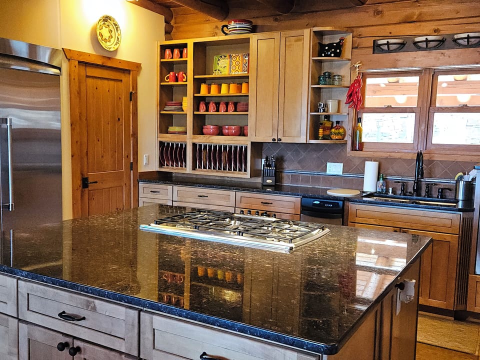 The gourmet kitchen features stainless steel appliances and granite countertops