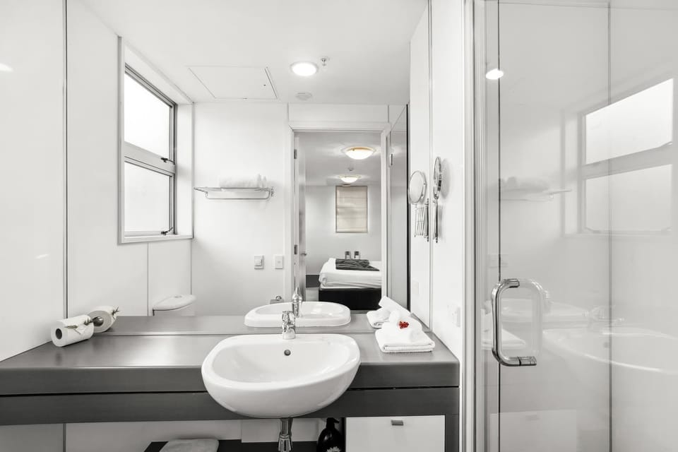 Modern bathroom with vanity and glass shower.