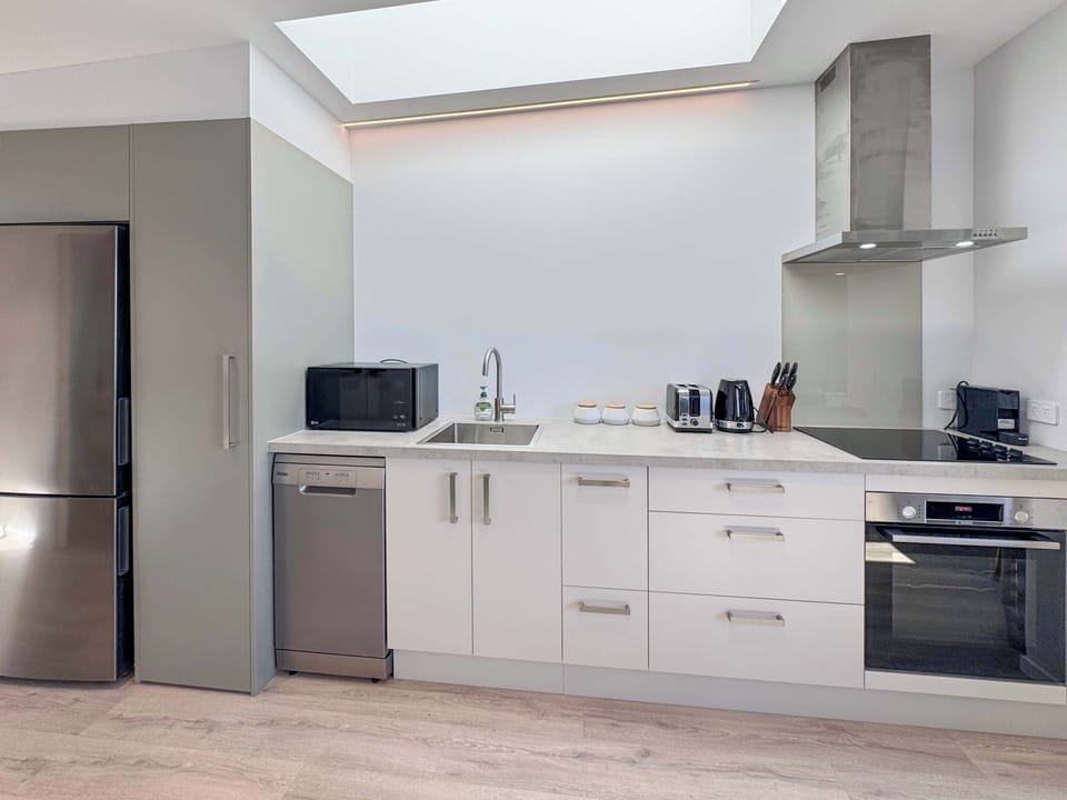 Light-filled kitchen with modern fittings and easy outdoor access.
