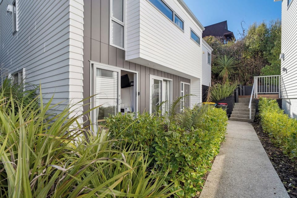 Private entrance with lush garden surroundings.