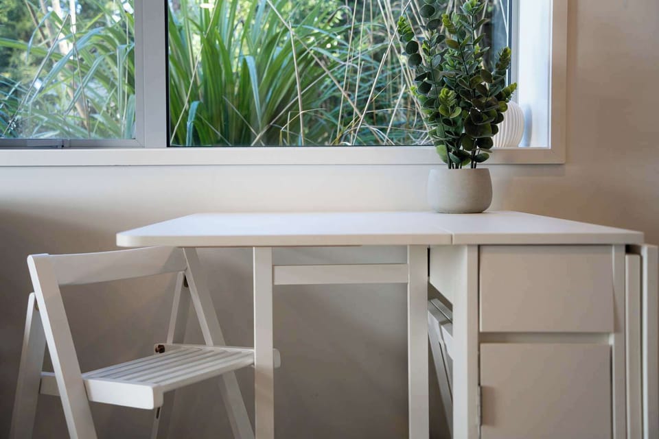 Compact folding table set for planning your Queenstown adventures with ease.