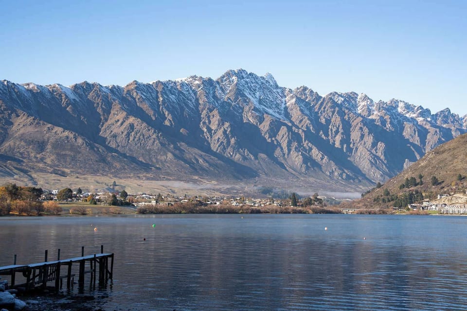 Peaceful lakefront scene framed by majestic mountains