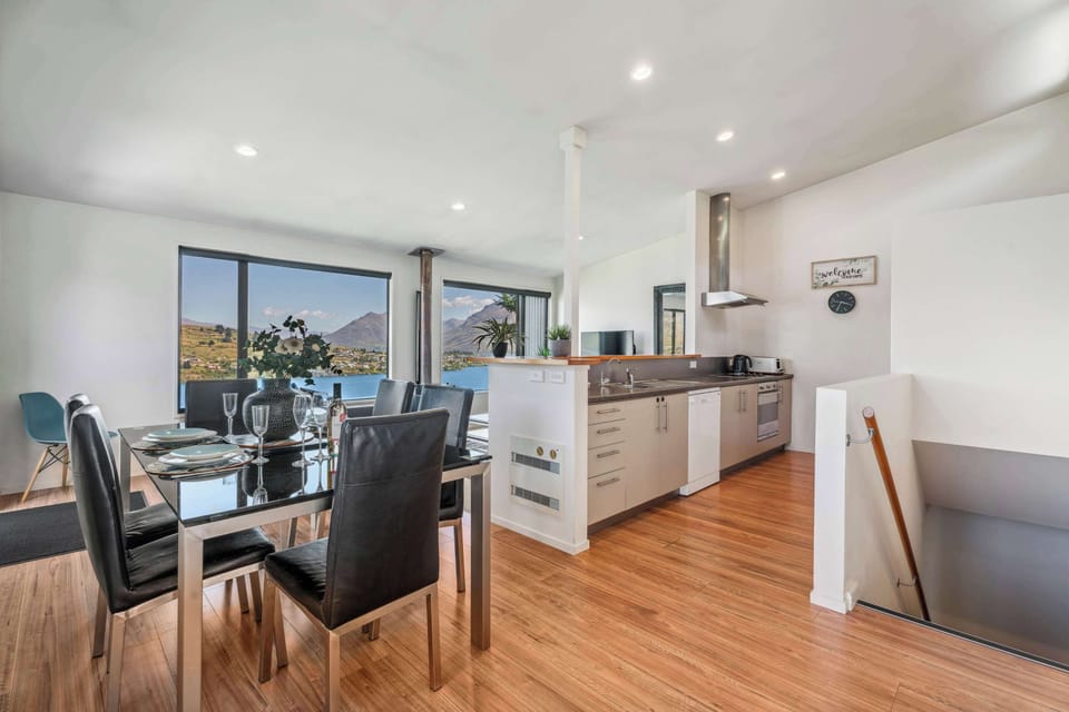 Wonderful open plan living with spectacular views from the kitchen, living room and dining room.  
The master bedroom and ensuite are on this ground floor, to the right.  The  other two bedrooms, laundry and main bathroom are downstairs.
