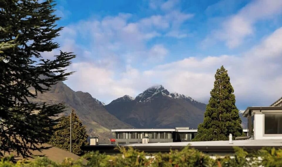 Mountain views framed by surrounding trees and rooftops