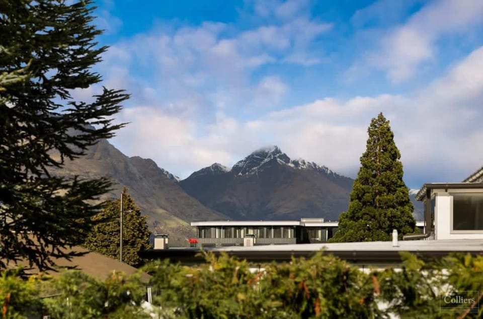 Mountain views framed by surrounding trees and rooftops