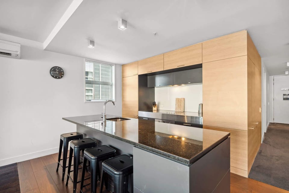 Contemporary kitchen with sleek design and full amenities.