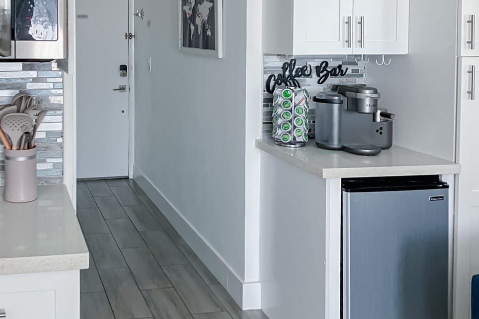 Enjoy your beach stay with this fully stocked coffee bar, featuring a Keurig setup and mini-fridge. Perfect for quick sips before heading out to the sand and surf.