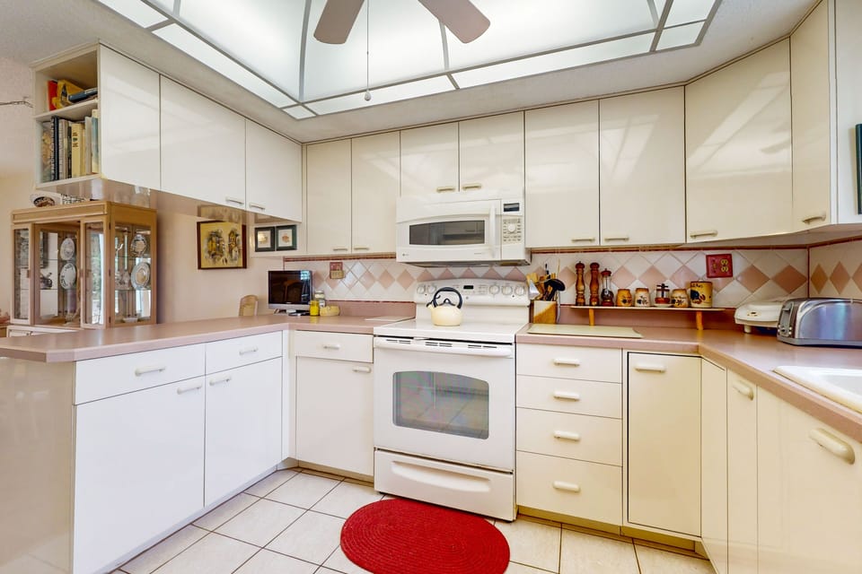 Enjoy the convenience of a bright, fully equipped coastal kitchen during your beach stay. With ample cabinetry and prep space, it's ideal for cooking meals and snacks between beach adventures.