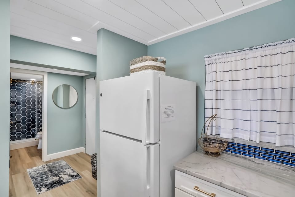 Enjoy a fresh, coastal kitchen designed for an easy beach stay. With modern appliances, clean finishes, and a functional layout, this space makes meal prep simple after a fun-filled day at the beach.