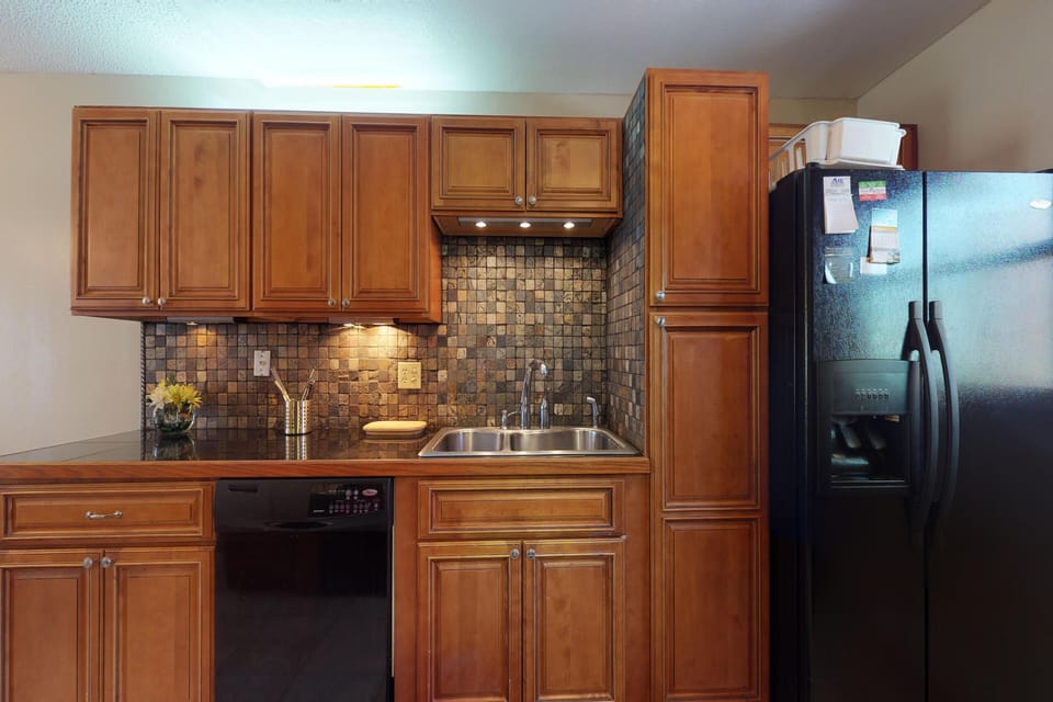 Enhance your beach stay with this modern kitchen offering ample cabinetry, full-size appliances, and plenty of counter space—ideal for preparing meals and enjoying relaxed coastal living.