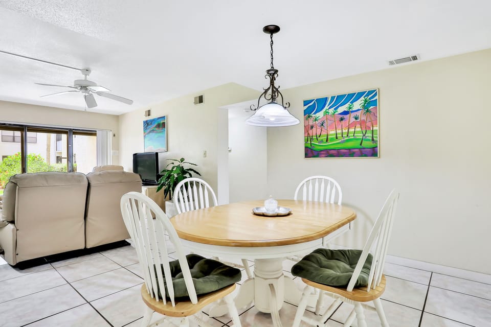 Gather in this bright coastal dining space, perfectly positioned near the living area. Ideal for a relaxing beach stay, it's a comfortable spot to share meals, plan seaside adventures, and unwind after the beach.