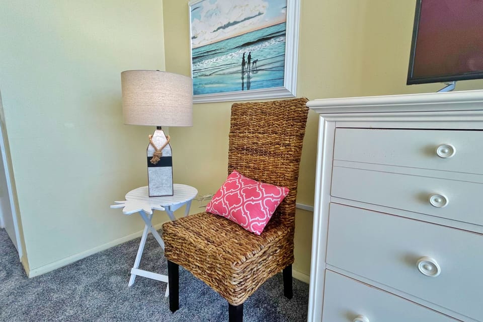 Unwind in this charming coastal reading nook featuring beach-inspired décor and comfortable seating—perfect for relaxing with a book or enjoying quiet moments during your laid-back beach vacation stay.