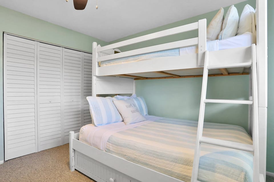 This bright bunk room features comfortable beds, ample storage, and beach-inspired décor. Perfect for kids or extra guests, it's a fun and relaxing space designed for memorable family beach stays.