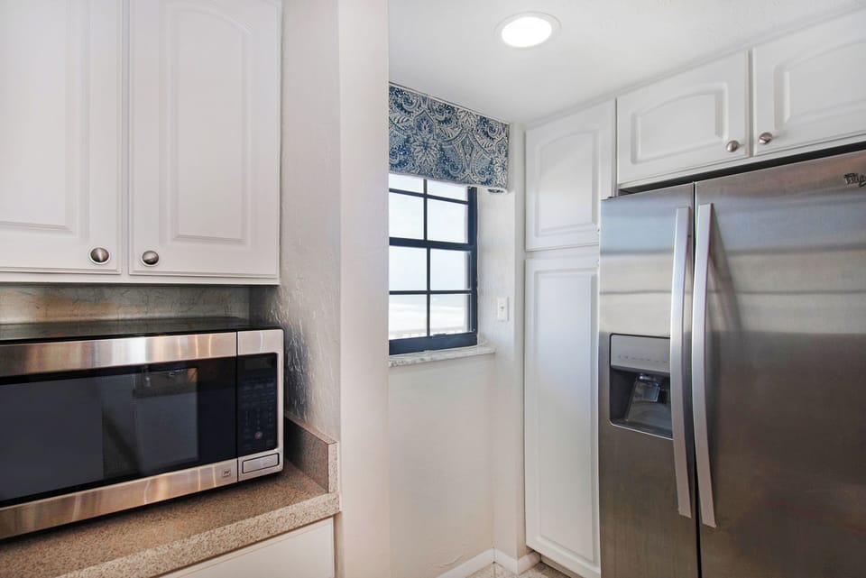 Enjoy the convenience of modern stainless steel appliances in this bright coastal kitchen. Designed for easy meal prep and comfort, it's perfect for fueling your days during a relaxed and carefree beach stay.