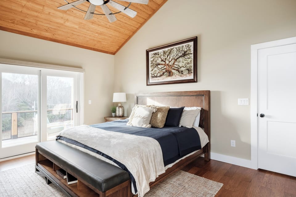 A serene king suite featuring soft linens, warm lighting, and a private ensuite bathroom. Designed for restful nights and peaceful mornings in the High Country.