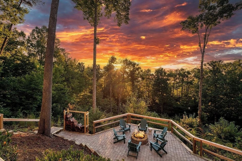 Welcome to your mountain escape. Enjoy breathtaking sunsets from this beautiful firepit terrace, surrounded by towering trees and peaceful forest views.