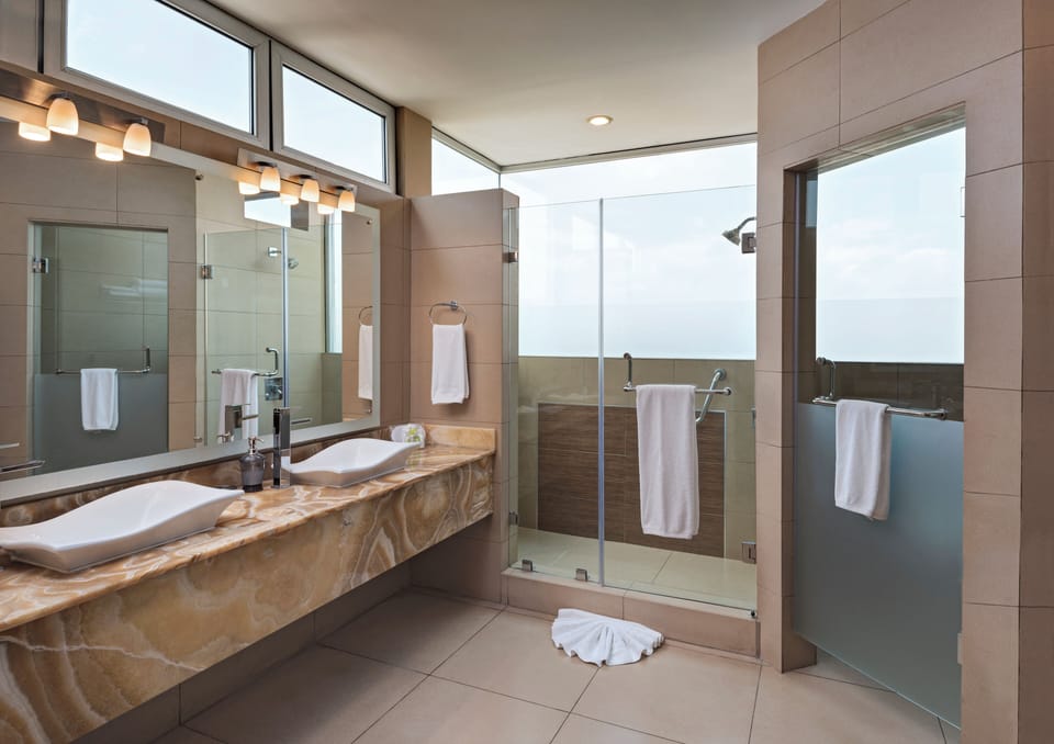 Suite, 1 King Bed | Bathroom | Shower, free toiletries, hair dryer, towels