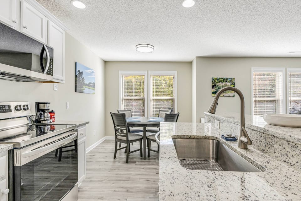 Kitchen with complete appliances spacious countertops for easy meal preparation.