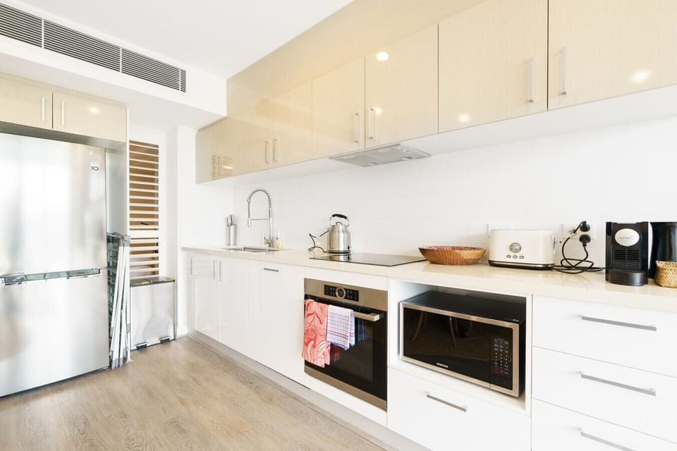 Modern kitchen with ample space, quality appliances, and clean finishes.