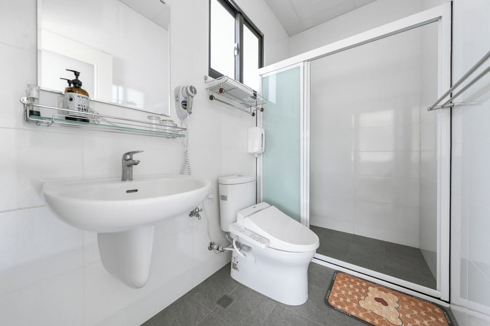 Shower, hair dryer, slippers, towels