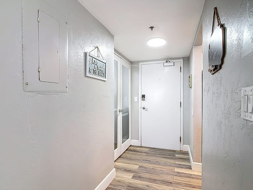 Entrance door and laundry machines just to the left of the entrance door